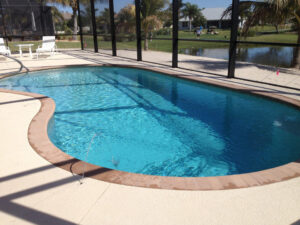 Sunny poolside with a screen enclosure