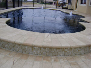Curved pool with stone border and jets