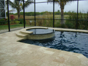 Screened pool with a spa and nature view