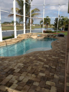 Enclosed pool with stone pathway and water view