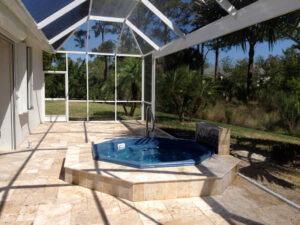 Screened hot tub with nature view and tiled deck