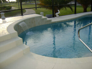 Curved pool with waterfall and golf course view