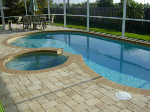 Pool with spa, patio, and screen fence