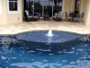Pool with fountain and patio furniture